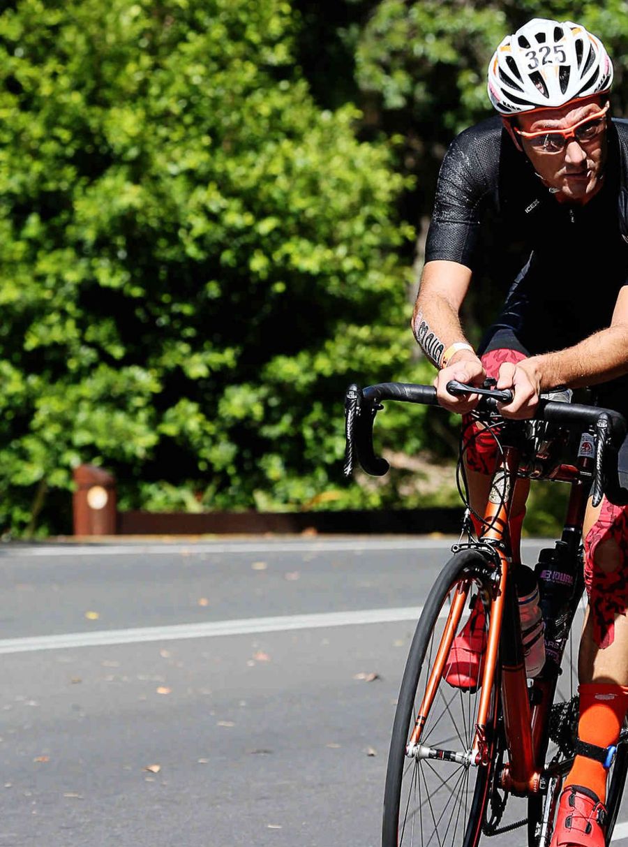 Giuseppe Gambarini riding with race number 325 during the cycling leg of the Hervey Bay 100 triathlon